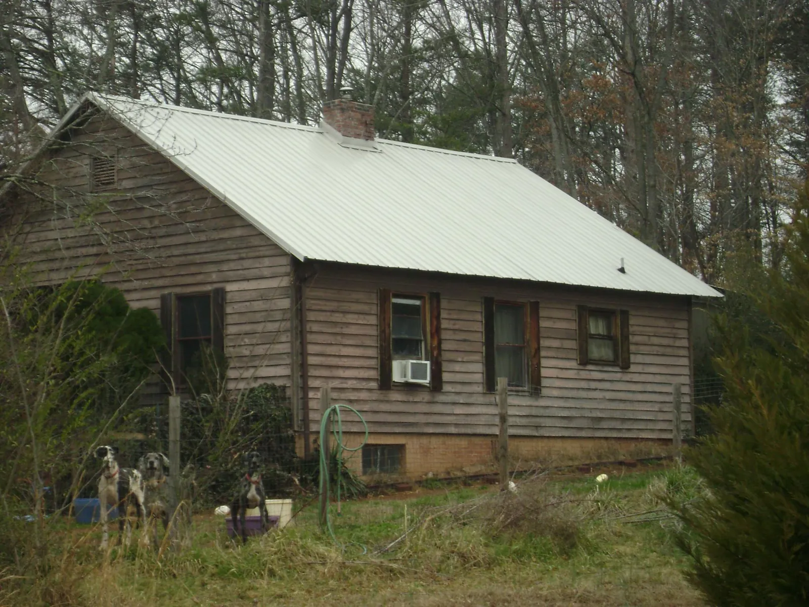 White metal roof on an old wood sided farmhouse, from a Asphalt Shingle Roof Repair job in Jamaica